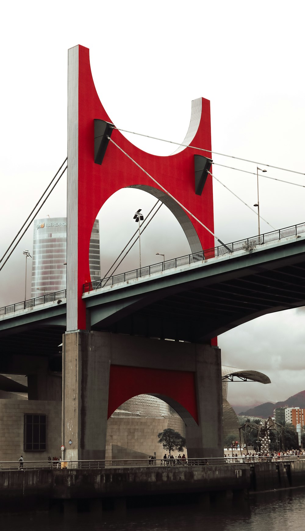 a large red bridge over water