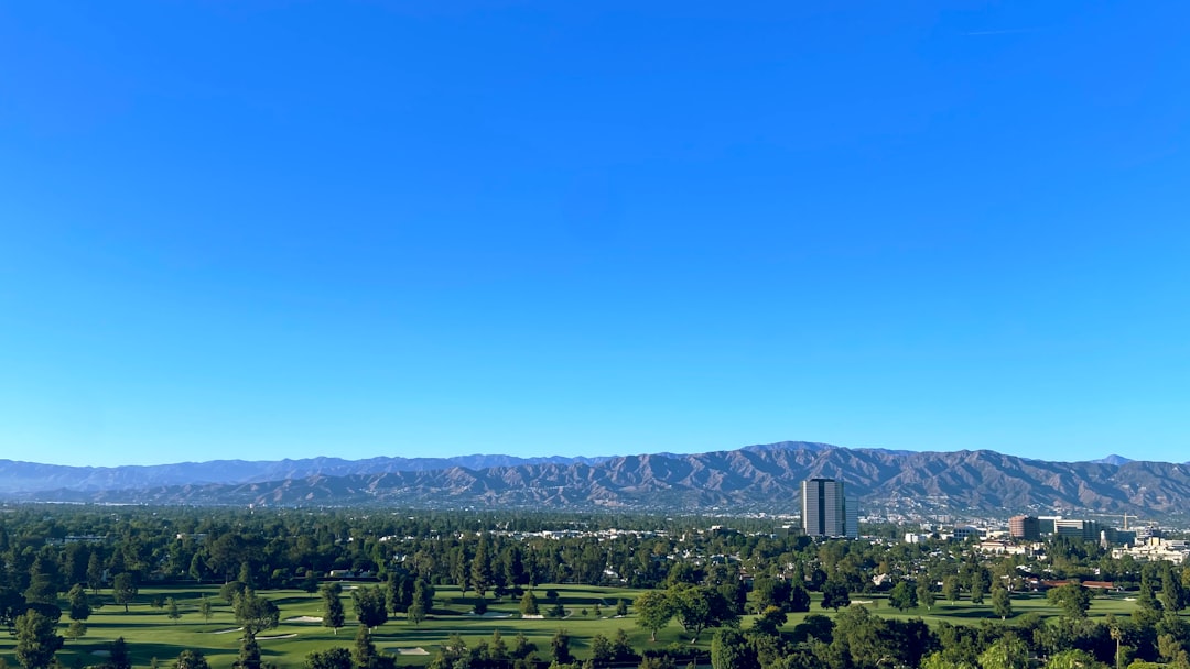 a large green landscape with buildings and trees,