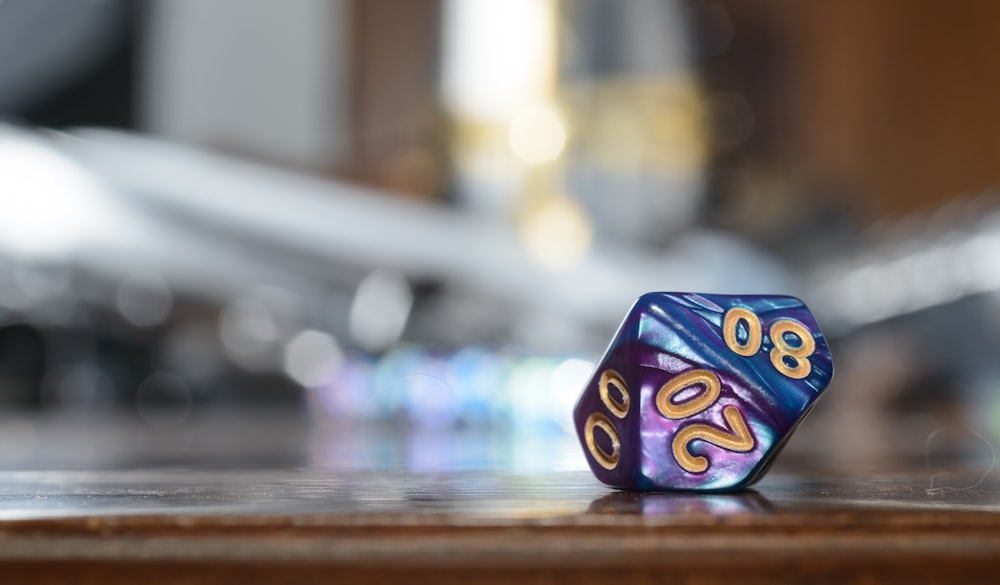 a small purple and blue dice