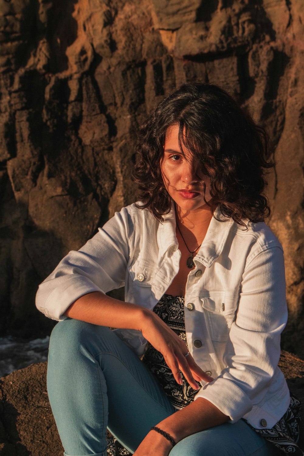 a person sitting on a rock