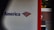 A partial view of a sign, displaying a recognizable red, white, and blue logo. The words 'of America' are visible, suggesting it is associated with a financial institution. The background shows a building with a brick facade.