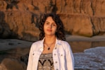 a person standing in front of a rocky cliff