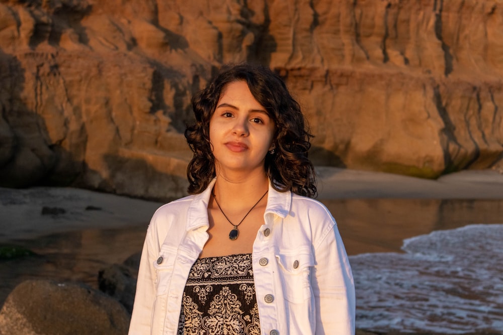 a person standing in front of a rocky cliff