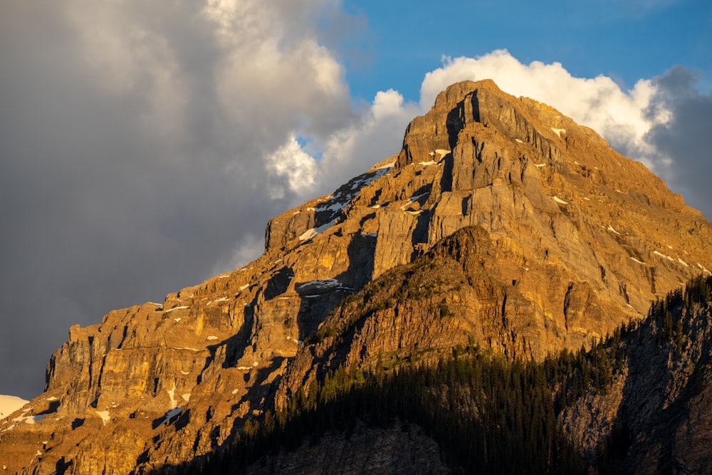 a rocky mountain with clouds