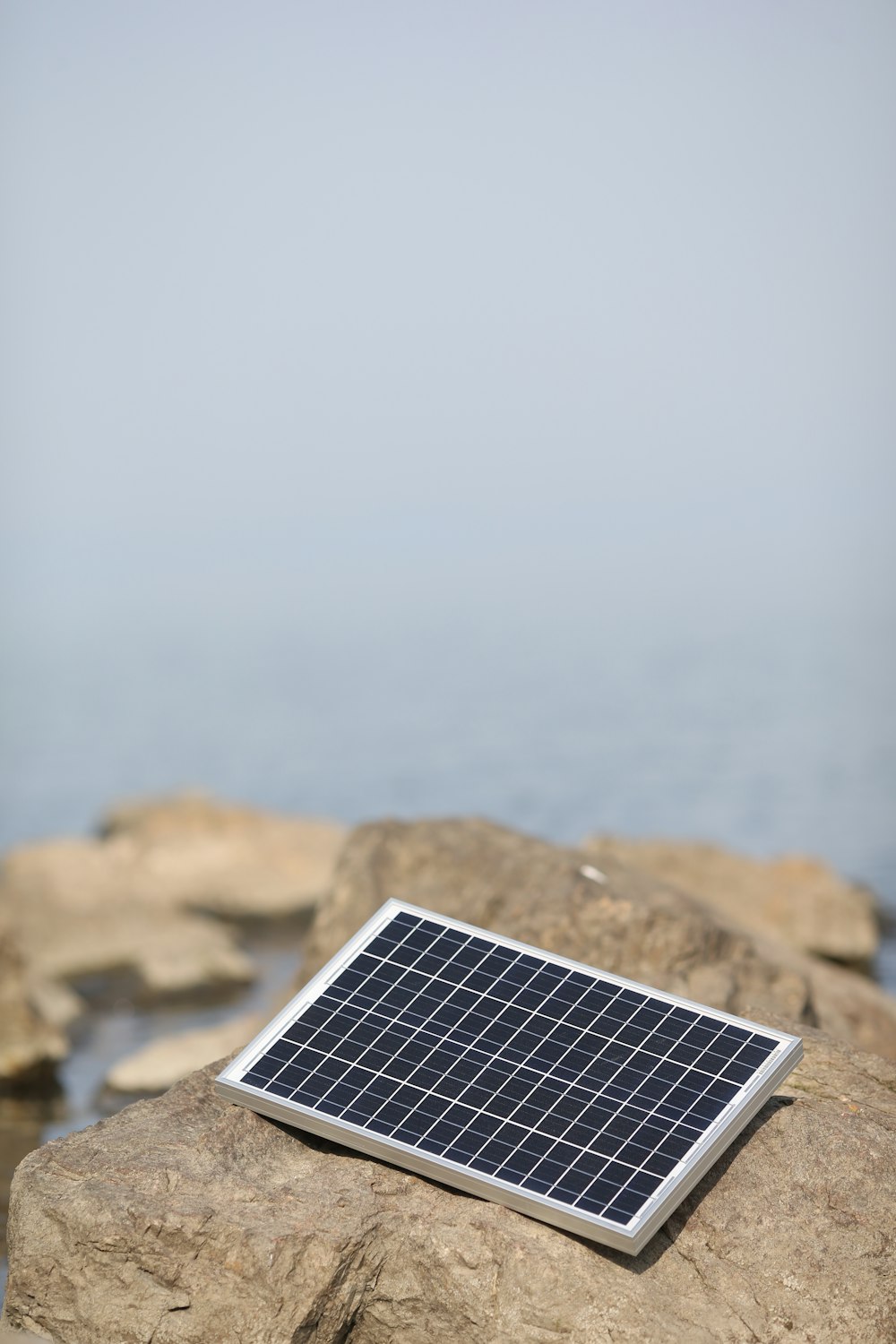 a solar panel on a rock