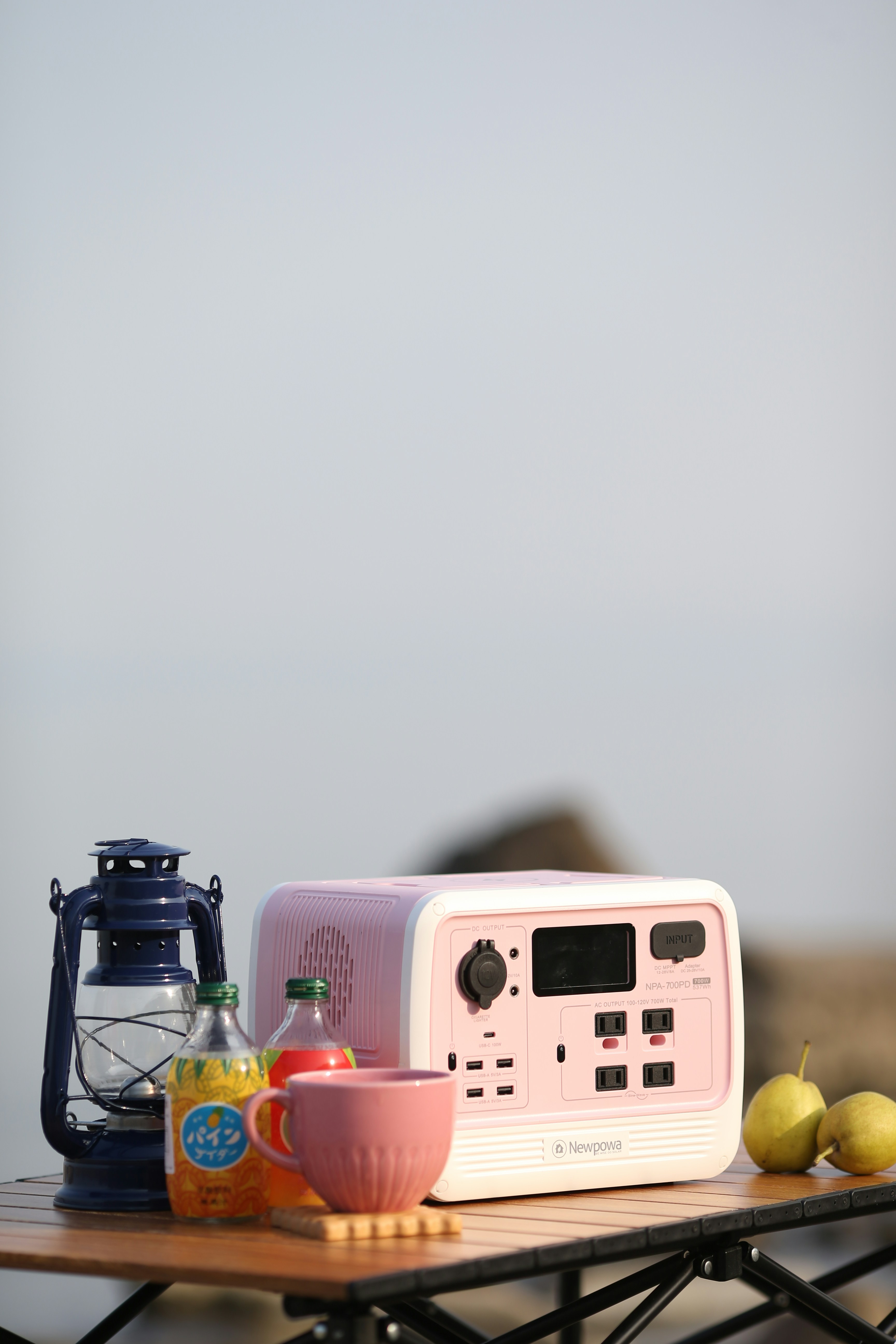 a pink tea kettle and a tea kettle on a table