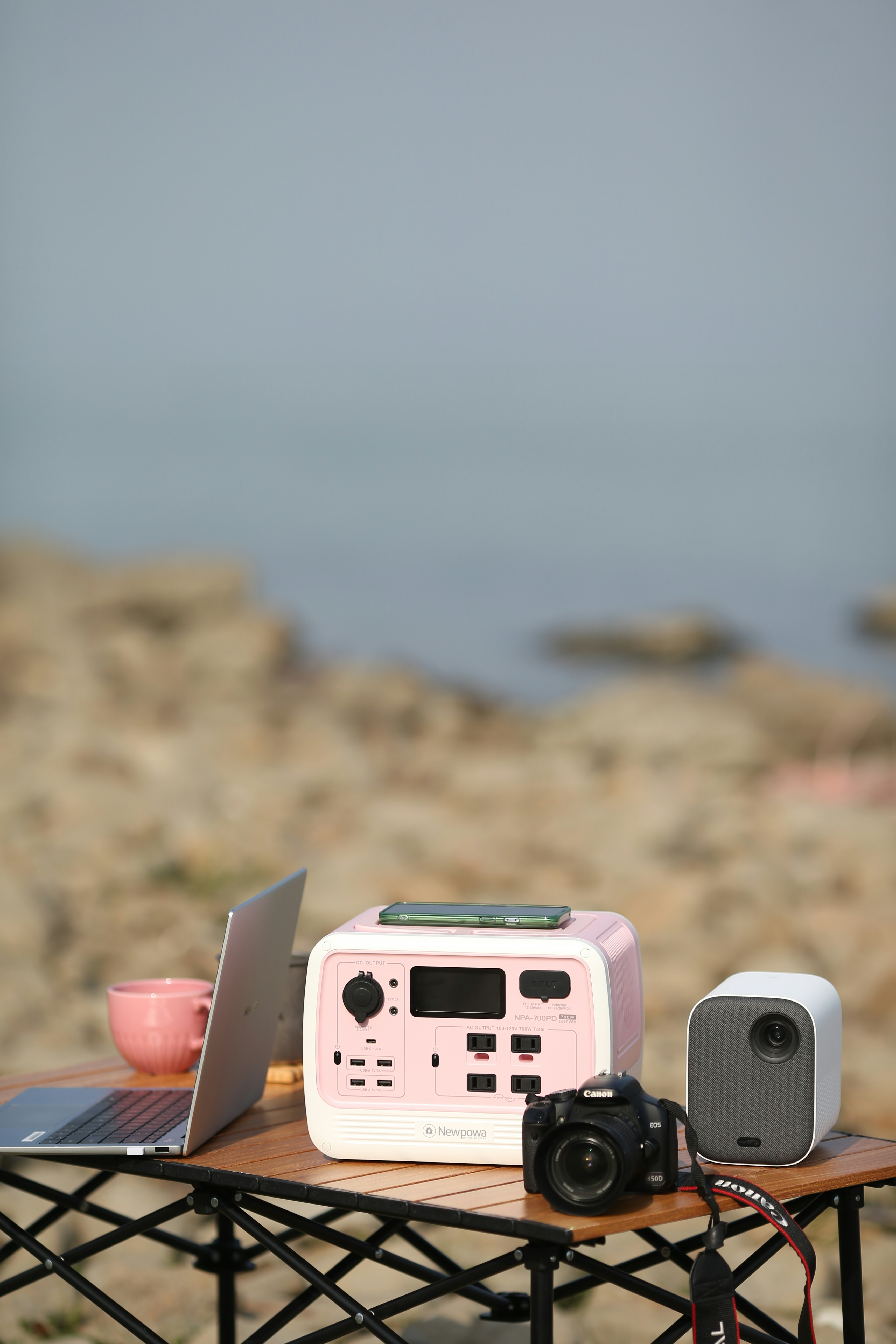 A pink and white toy car on a table with a camera