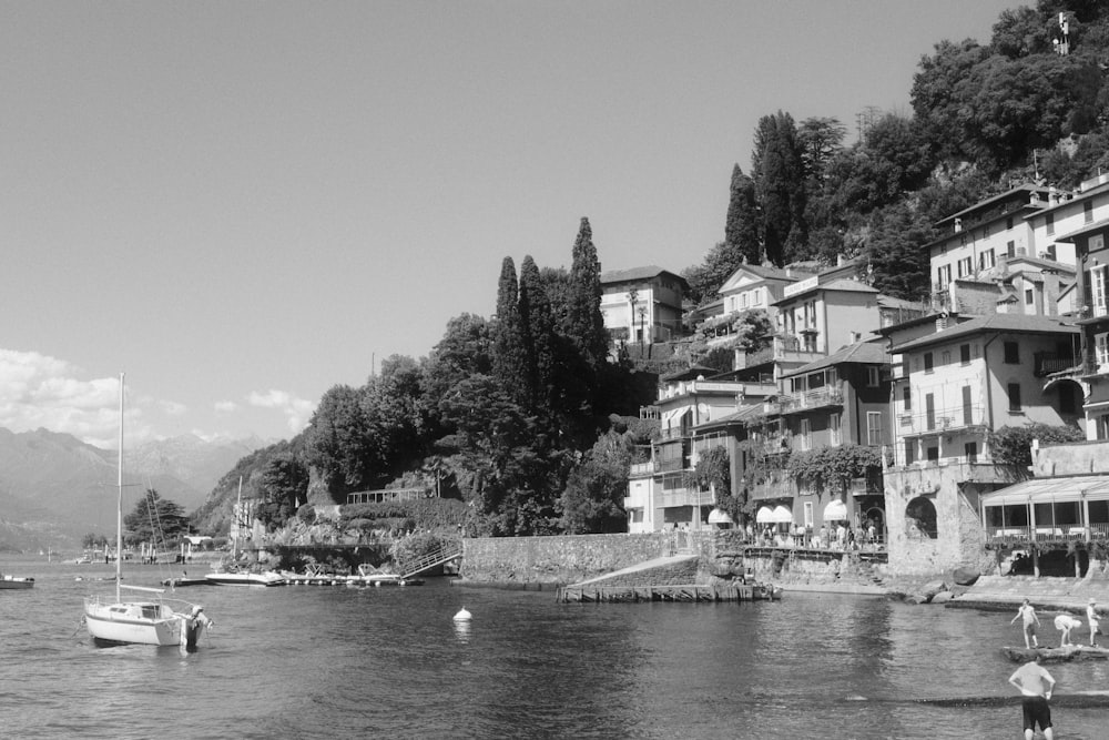 a group of people stand on the edge of a body of water