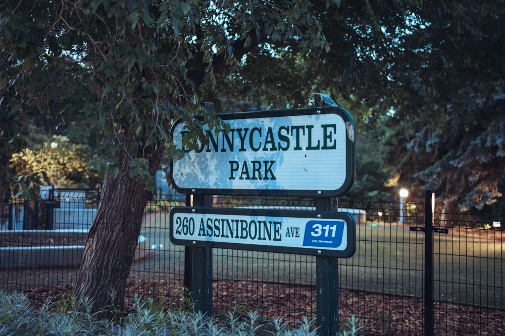 a street sign is posted on a fence