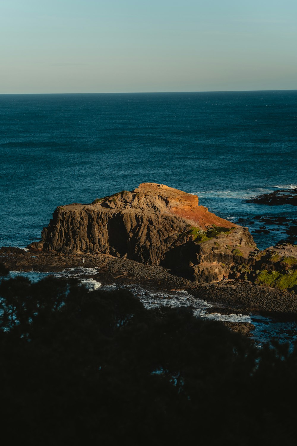 a rocky cliff next to the ocean