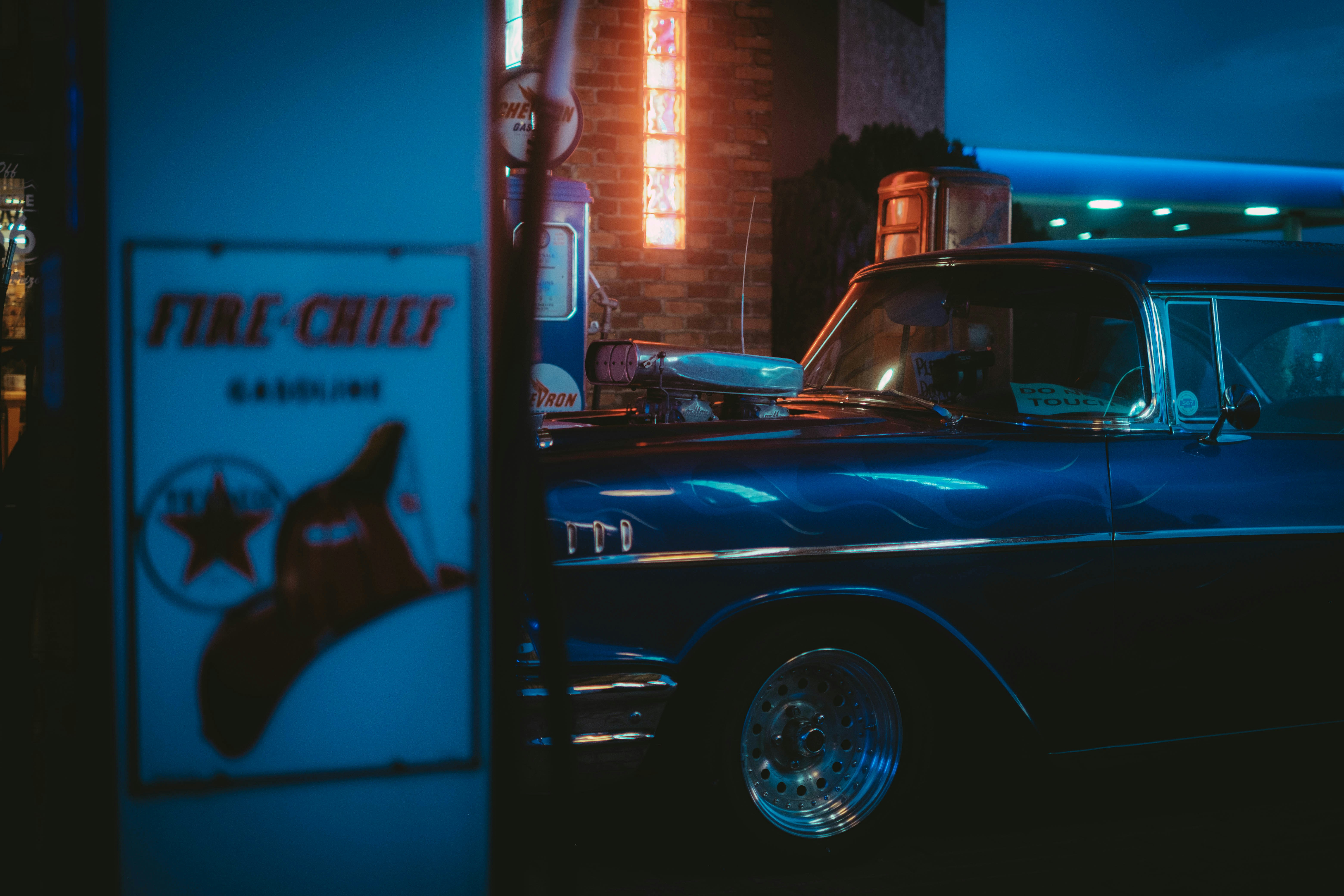 um carro da polícia estacionado ao lado de uma placa