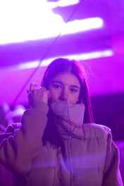 Close-up of a fantasy RPG character avatar glowing in dark purple hues