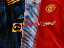 a pair of blue and red striped shirts with white text