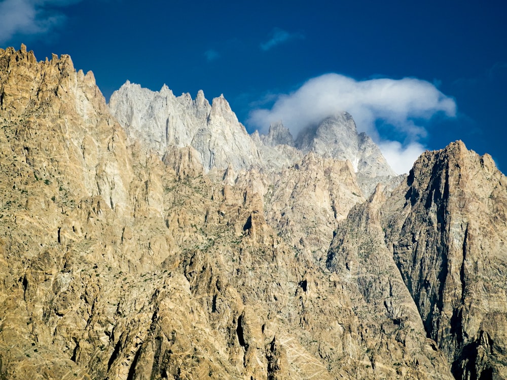 a rocky mountain with clouds