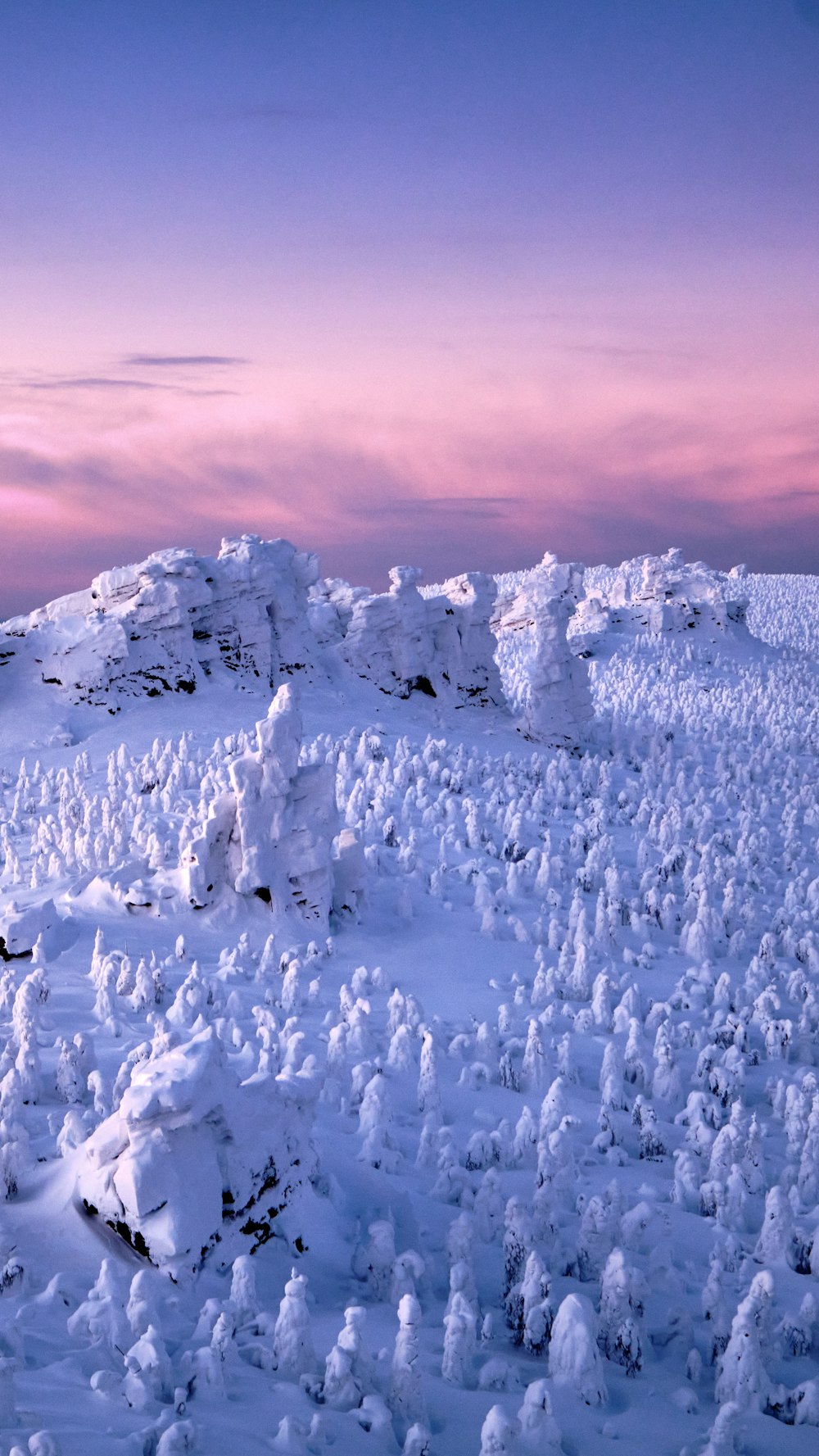 a snowy mountain with a purple sky