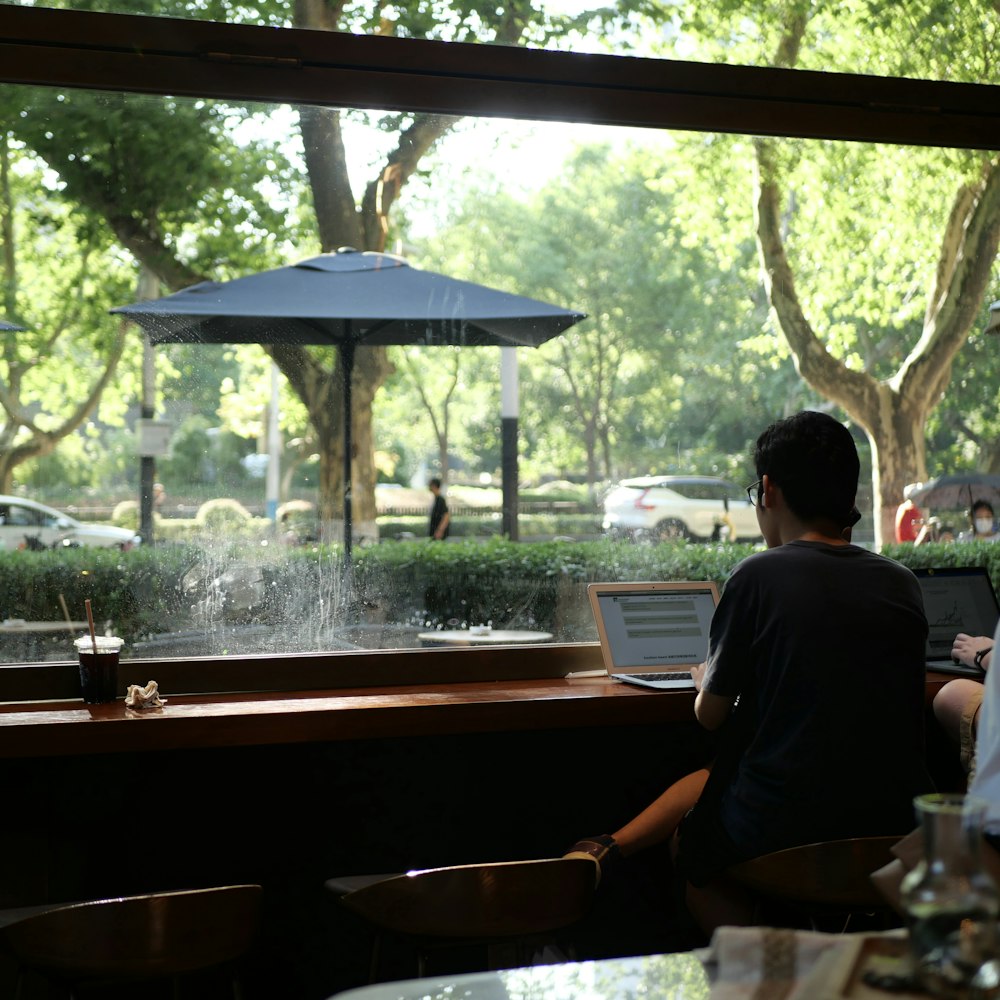 a man sitting at a table with a laptop