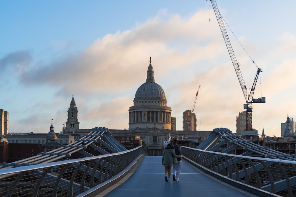 a couple walking on a bridge