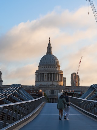 a couple walking on a bridge