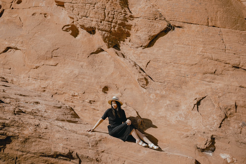 a person sitting on a rock