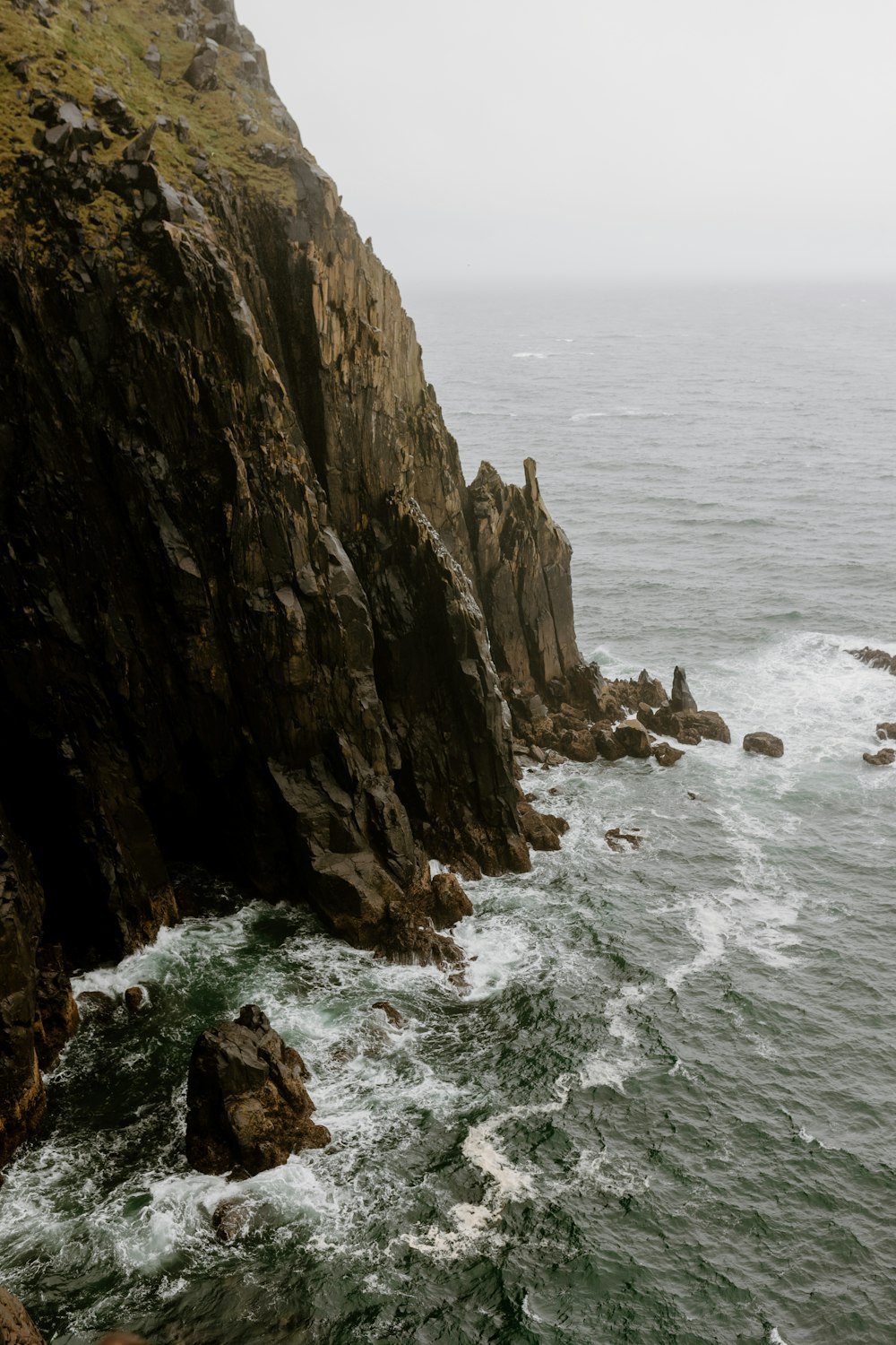 a rocky island in the middle of a body of water