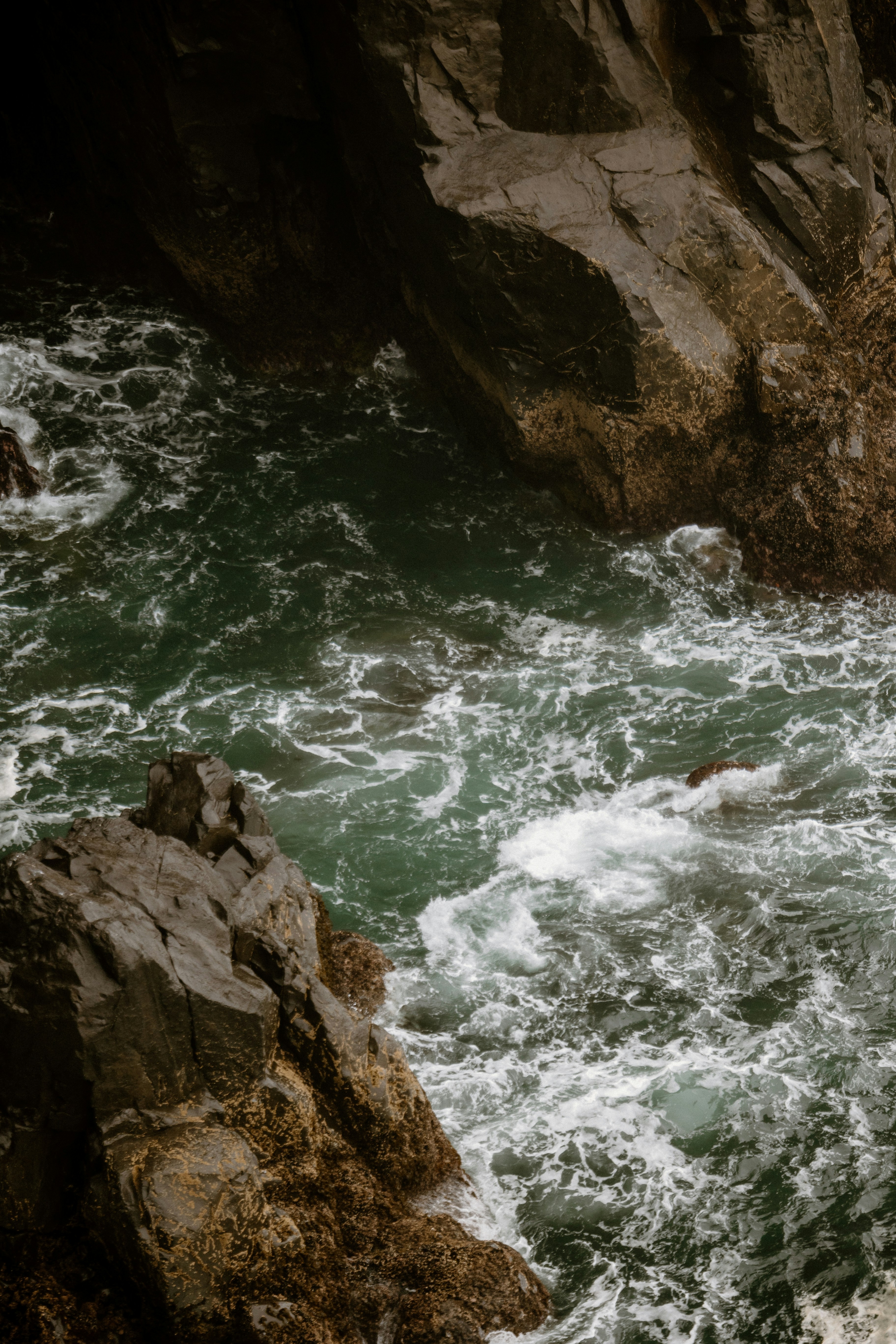 a man standing next to a waterfall