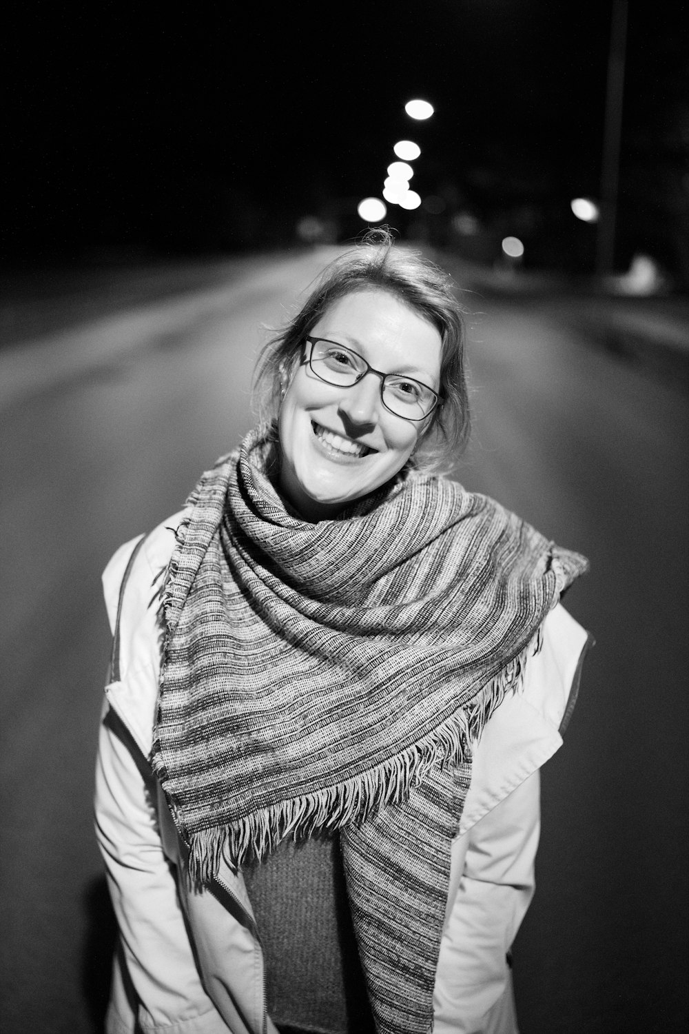 a person wearing glasses and a scarf