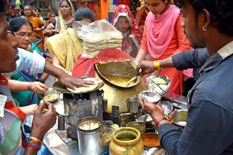 a group of people cooking in a kitchen