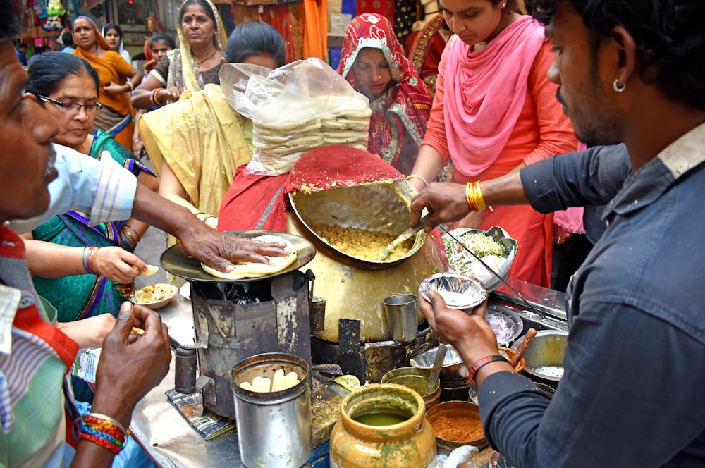 a group of people cooking in a kitchen