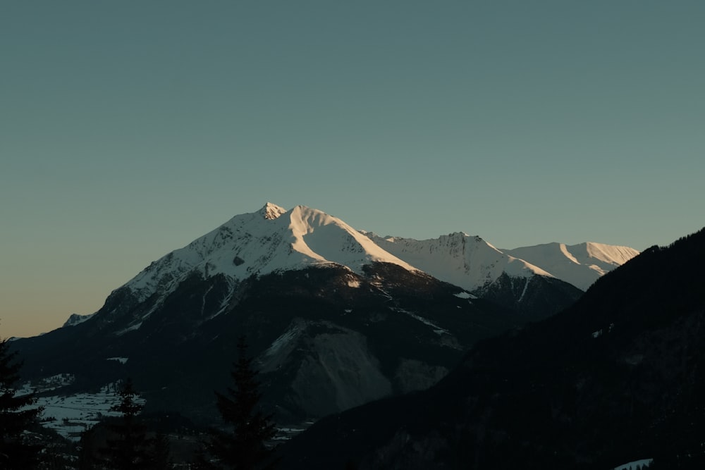 a snowy mountain with trees