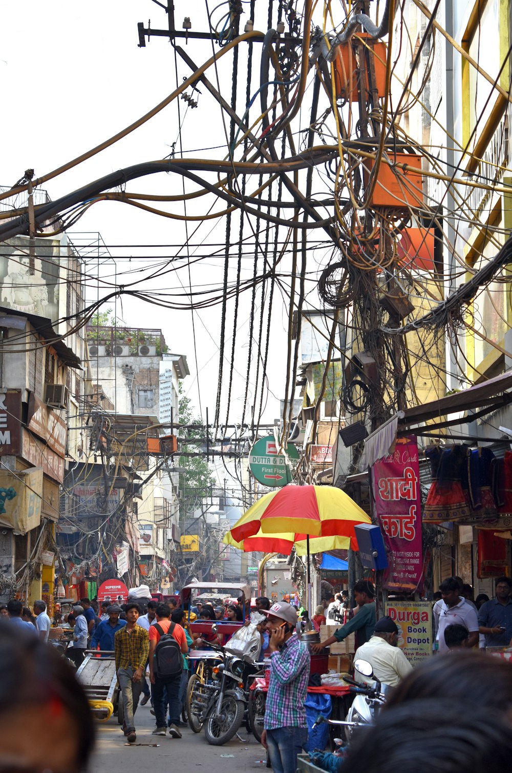 a busy street with people and umbrellas