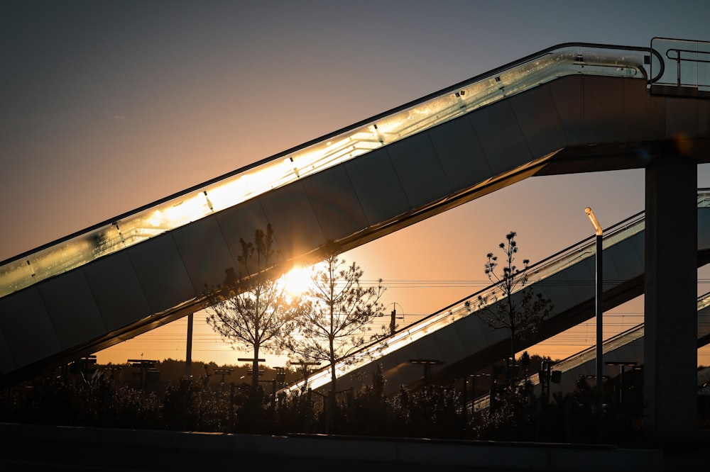 a bridge with a sunset