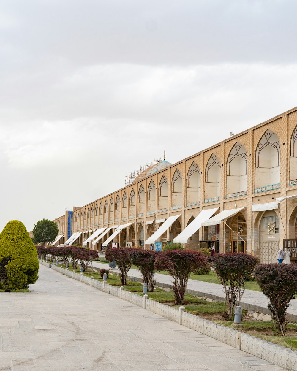 a building with a walkway and trees