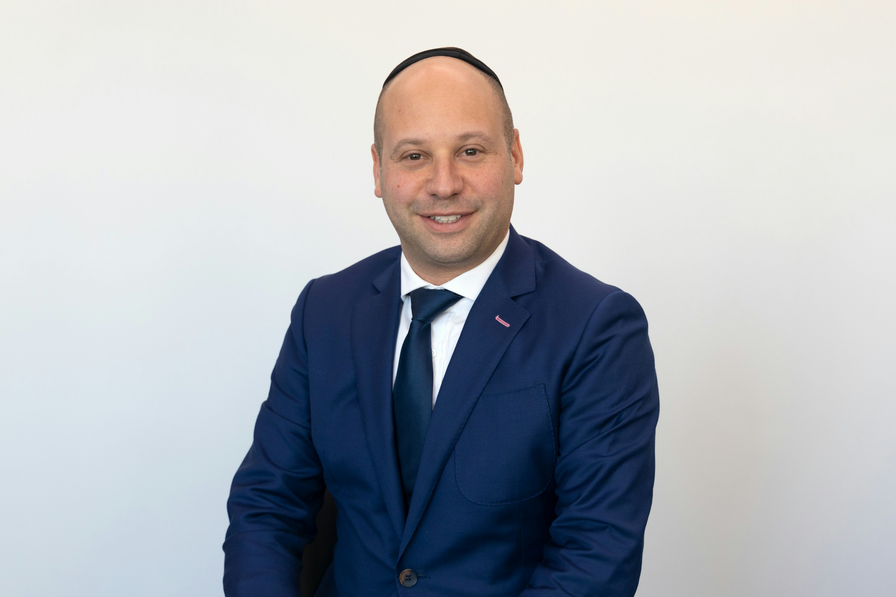 Headshot of Jewish Lawyer welcoming and smiling
