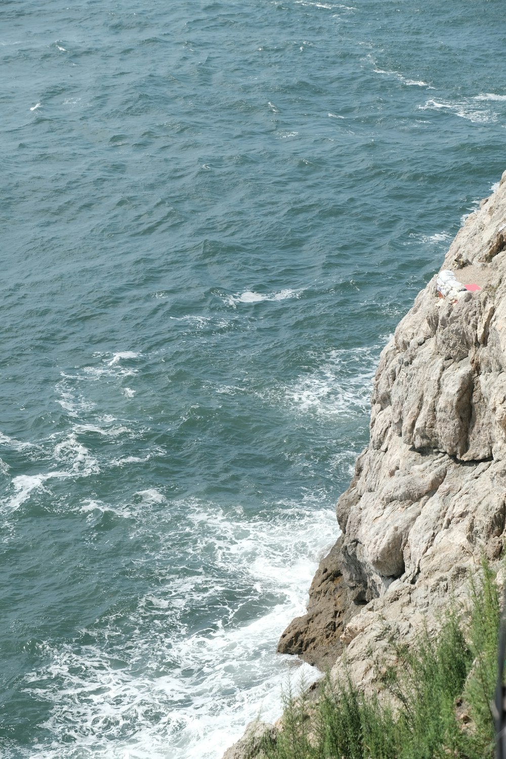 a body of water with rocks and a beach