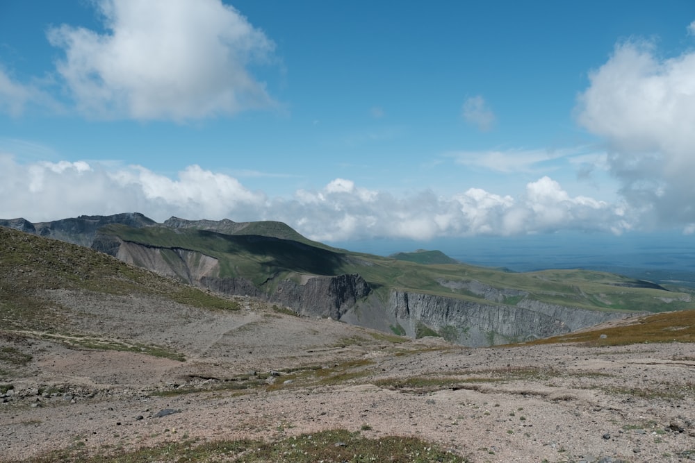 a landscape with hills and a blue sky