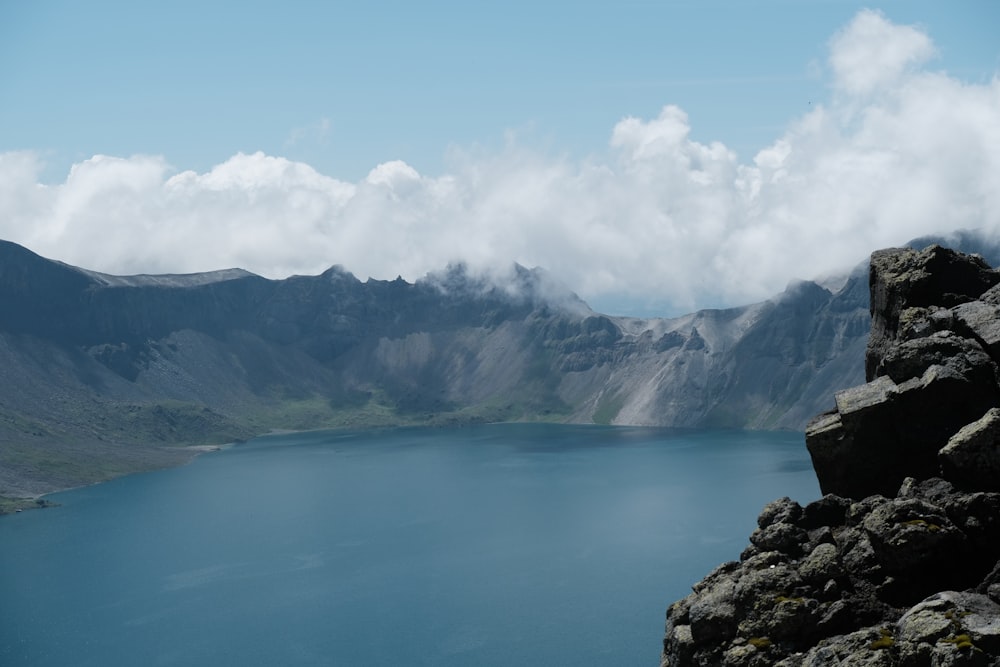 a body of water with mountains in the back