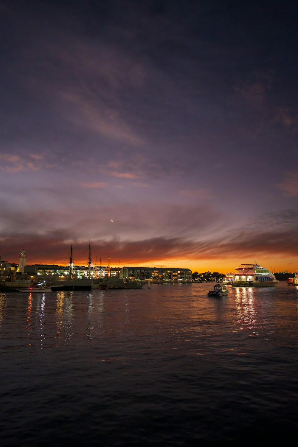 a body of water with boats and buildings in the background