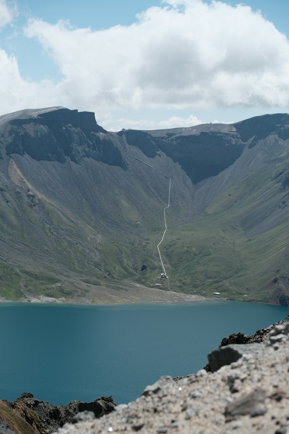 a body of water with mountains in the back