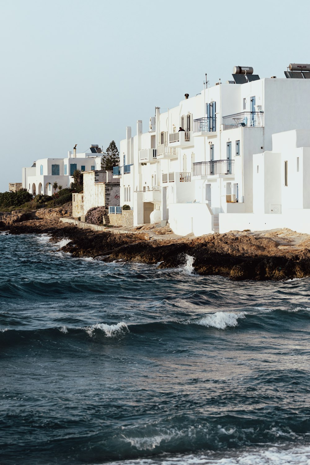 a white building on a rocky shore