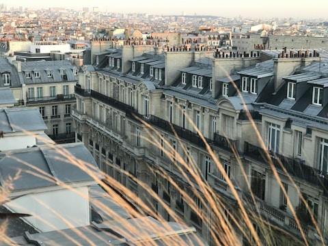 Wide shot of a Lyon rooftop with newly rebuilt brick parapet.