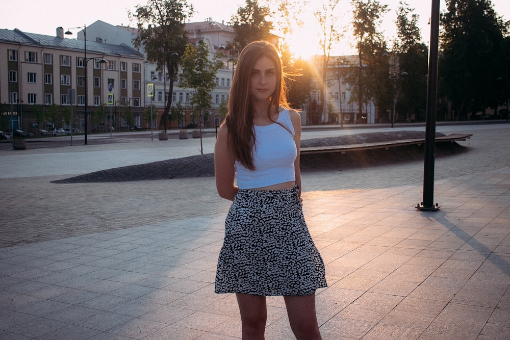 a woman standing in front of a fountain