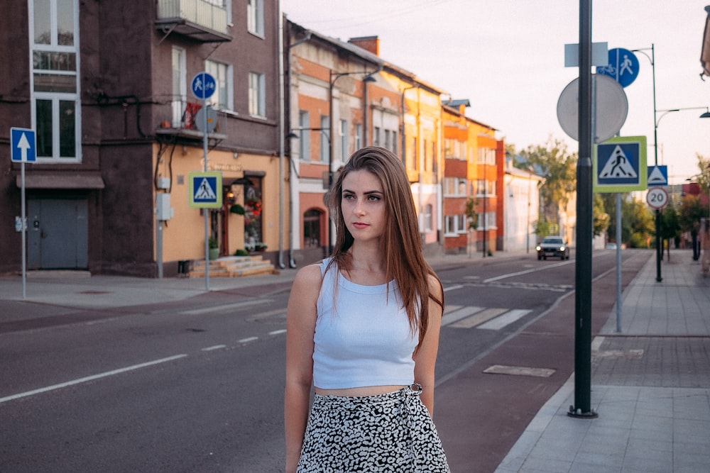 a woman standing on a street corner