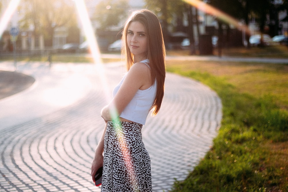 a woman standing on a sidewalk