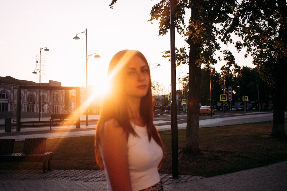 a woman standing on a sidewalk