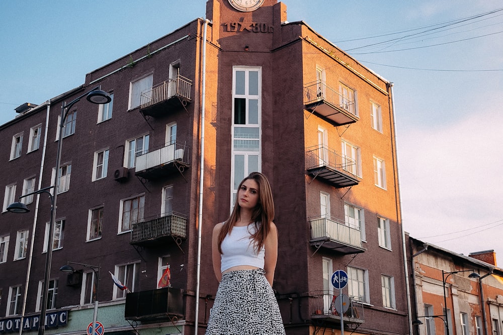 a person posing in front of a building