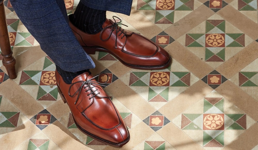 a person's feet on a patterned floor