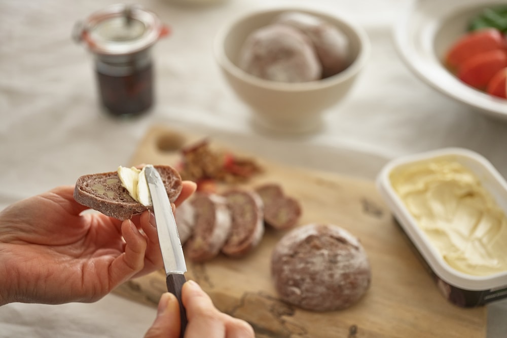 a person cutting meat with a knife