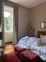 A bright, inviting bedroom with modern furnishings and subtle renovation fixes applied.