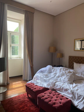 Sunlit bedroom showcasing spacious layout and neutral colors.