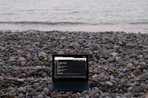 a tablet on a rocky beach